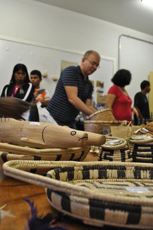 A fish wood carving of indigenous Brasilian artwork. All the crafts are handmade and use various natural materials such as gems, beads, wood and straw